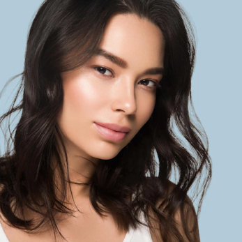 half asian young woman with brown hair and glowing skin